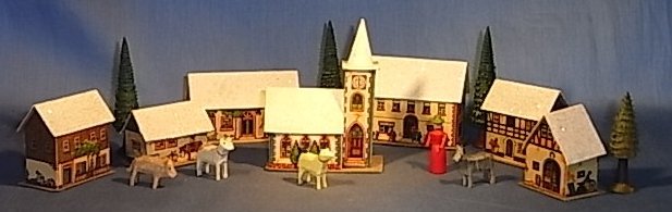 Early German cardboard Christmas village, before electric lighting.