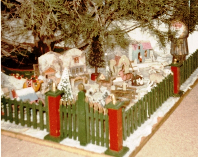 Portion of Christmas tree village under cedar tree - 1967