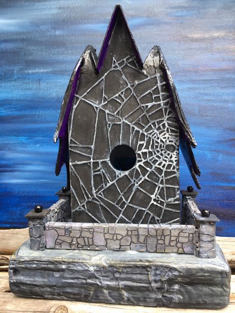 Spiderweb design on the back. Also shows the stone wall.