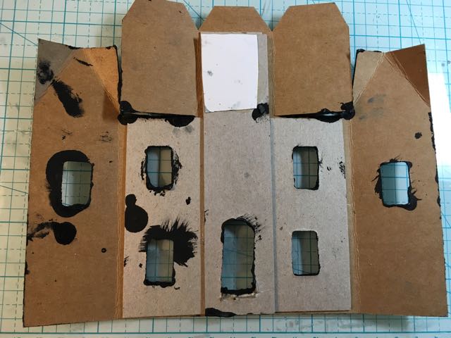 Reinforcement cardboard for the front piece of the Clock tower house. 3 layers for the tower. White paper is the back of the clock.