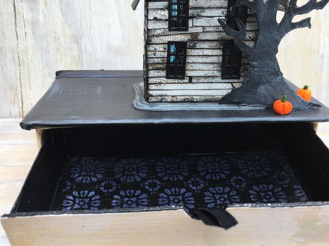 Drawer opened up. This is technically the back side, but both front and back are decorated. Only the front has a door.