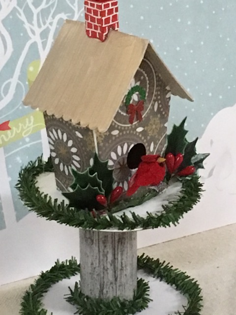 Little birdhouse on a ribbon roll as a stand