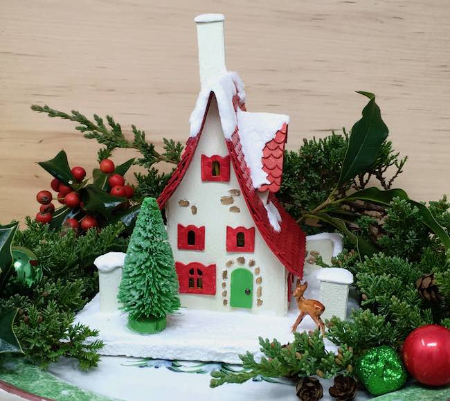 Little red roof cottage putz house in holiday greenery.jpg