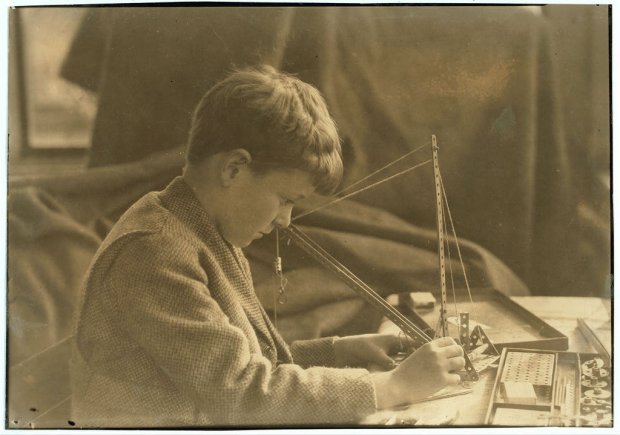 boy with 1920s Erector set